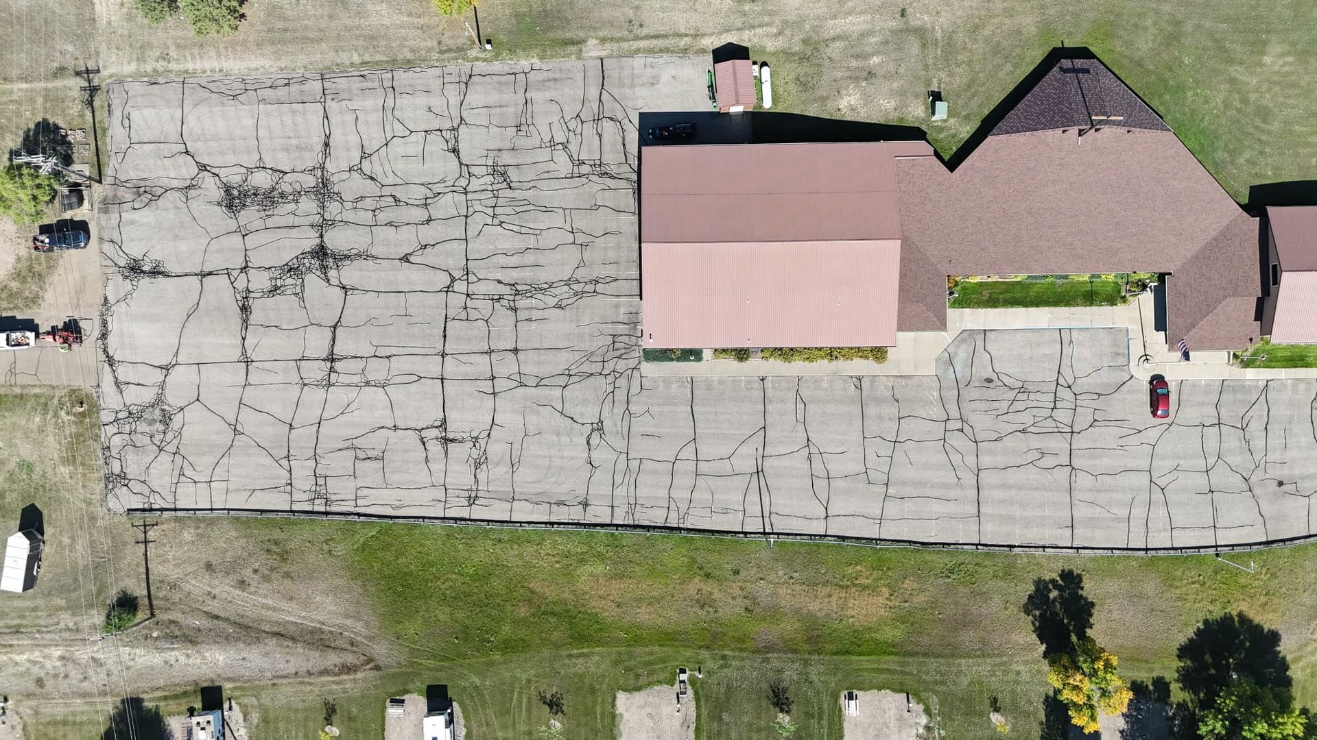 Gallery photos for Crack Sealing a Heavily Damaged Church Parking Lot in Beulah ND: Image #1